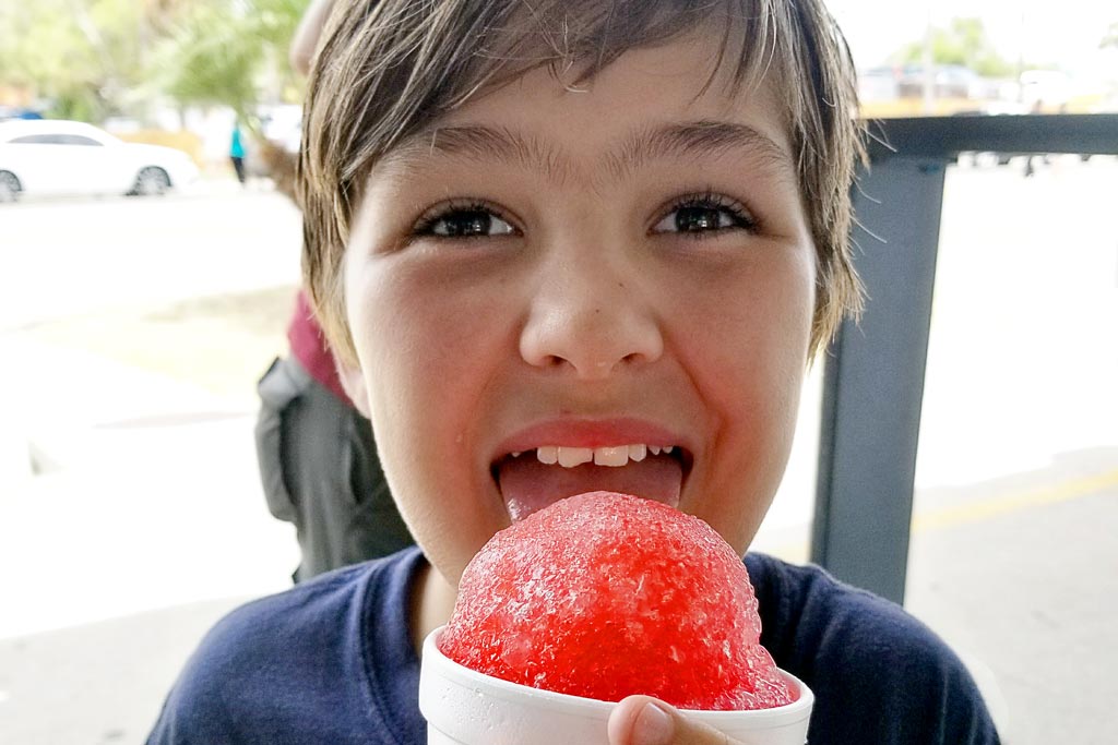 Boy eating a red Snowcone at the USS Lexington