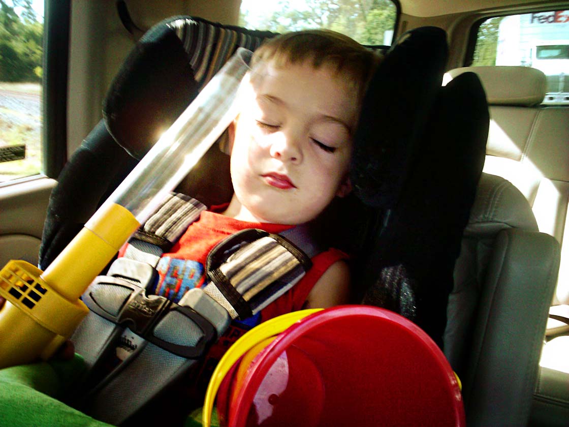 napping child with bug sucker and a bucket