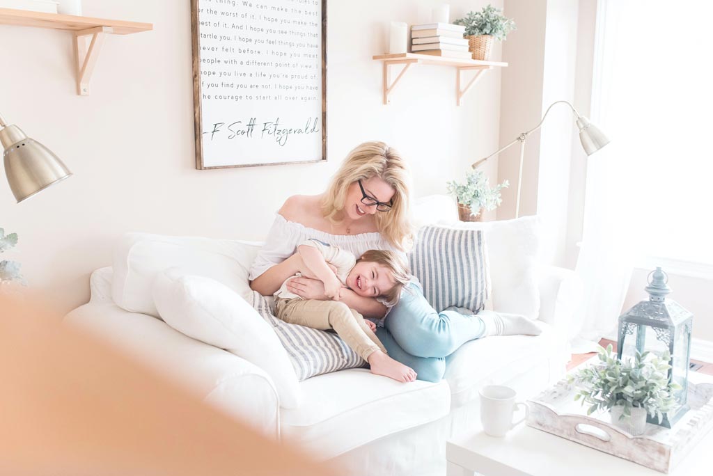 back to school Houston 2021 - Mom and daughter hugging on white couch