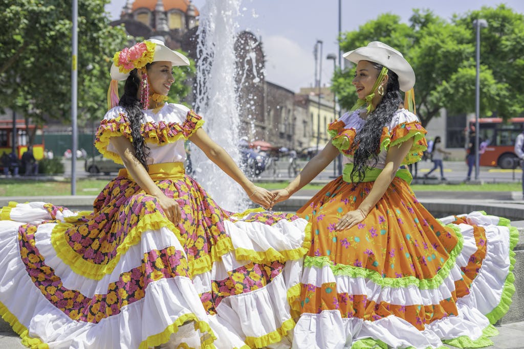 Women in Jalisco Dress Sitting by Fountain
