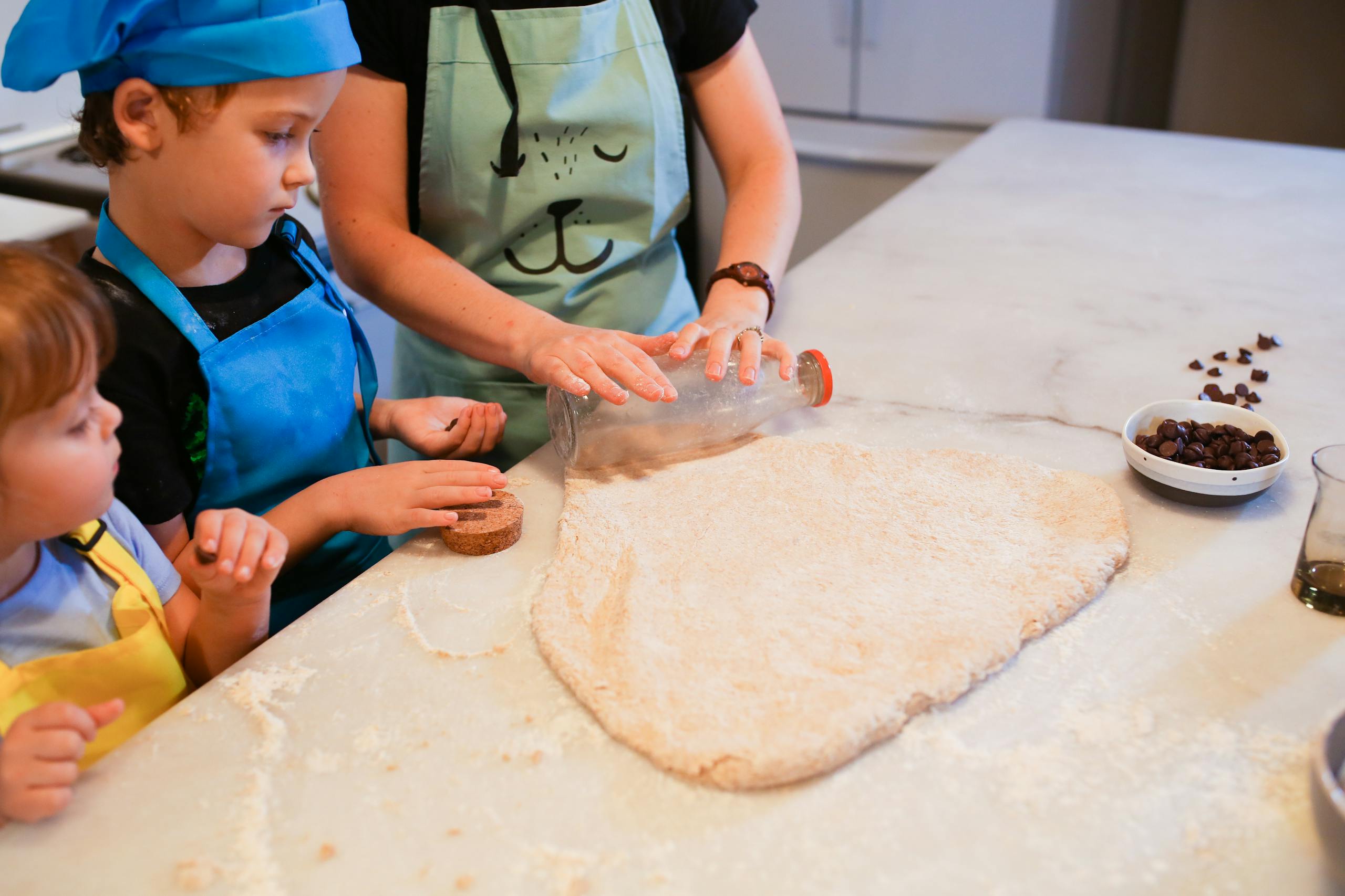 Woman in Blue Apron Holding Dough