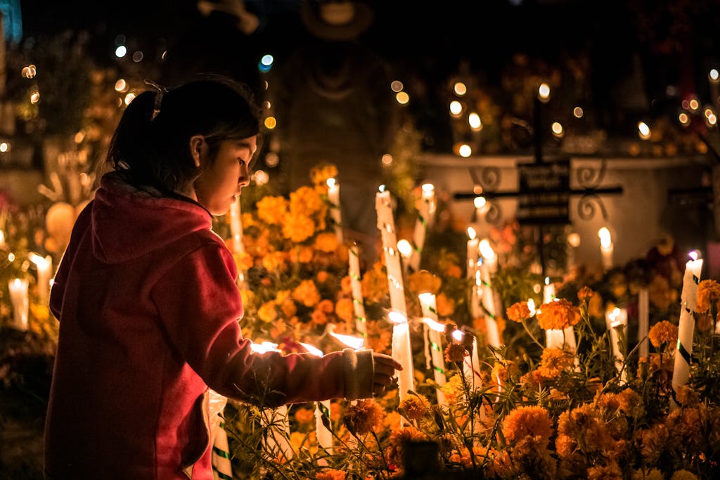 Woman over Flowers and Candles on Dia de Muertos